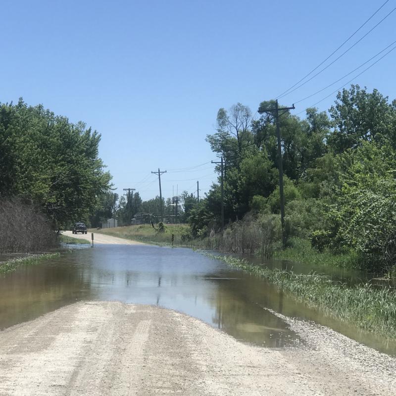 Flooded road that runs between Hwy. 218 and the river
