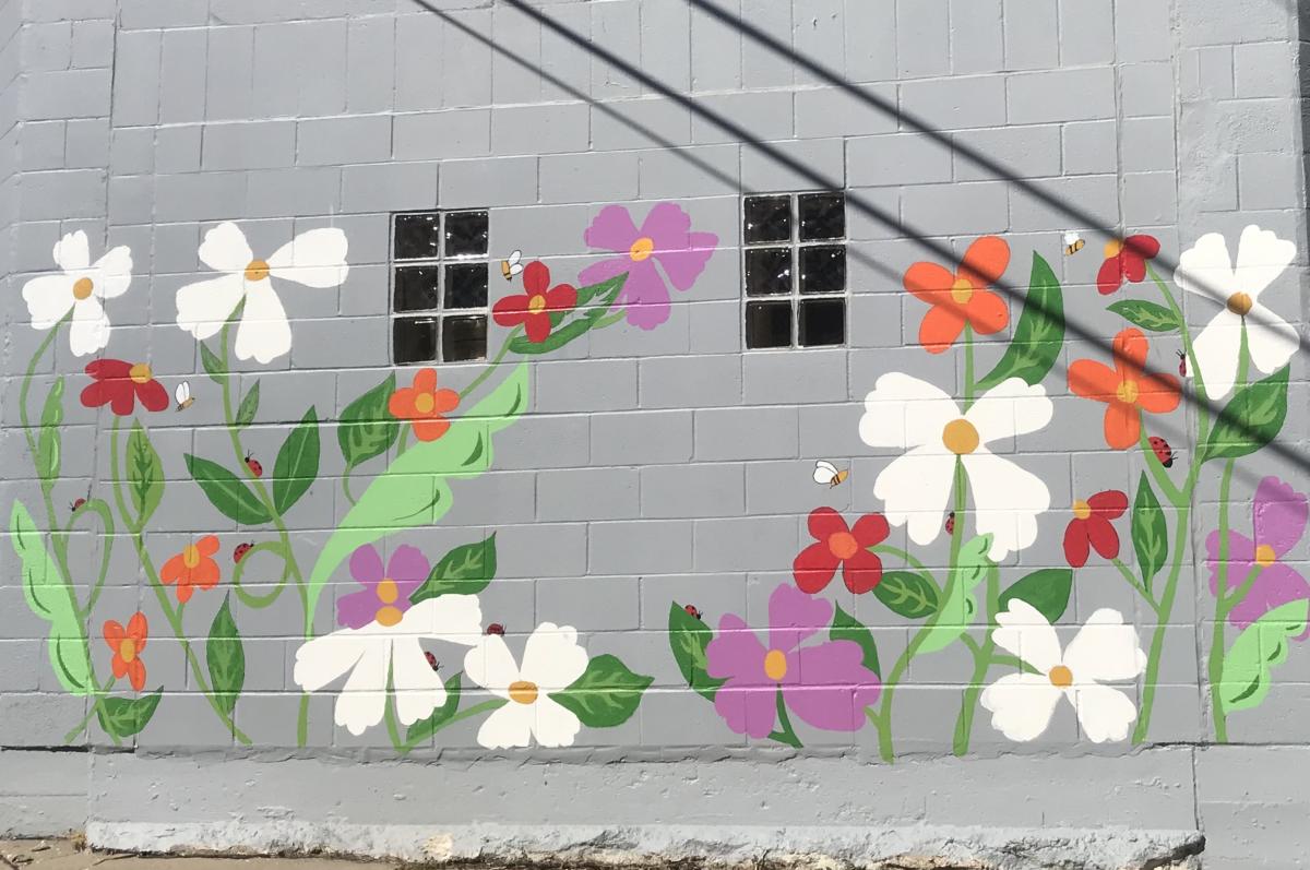 A new mural in the alley behind City Hall now brightens the downtown