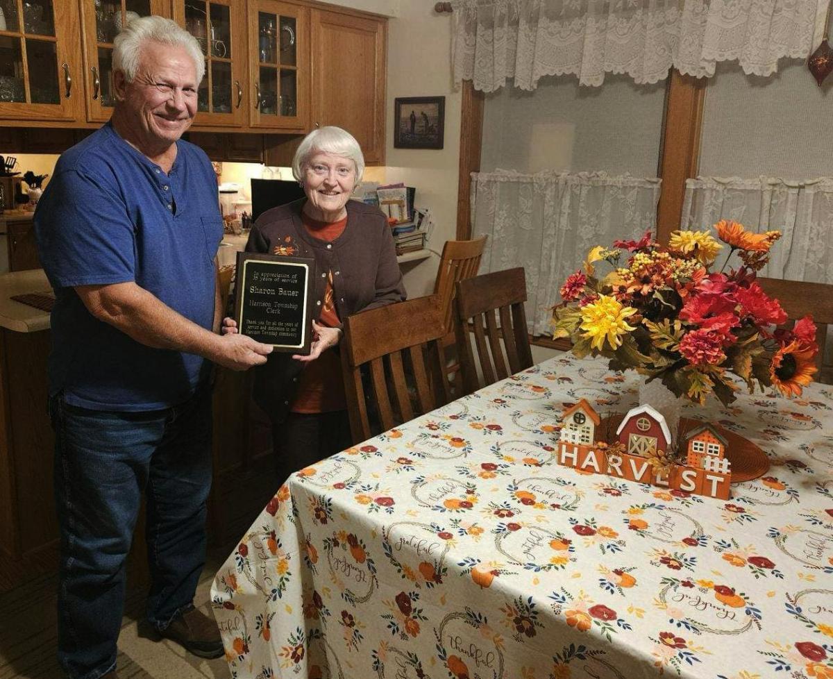 Sharon Bauer accepting a plaque thanking her for her service