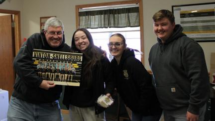 Members Megan Schlitter, Bri Dulin, and Will McKenna gifted Bob Hanson from Pioneer with cookies and a poster to hang in the office.. Click to read article