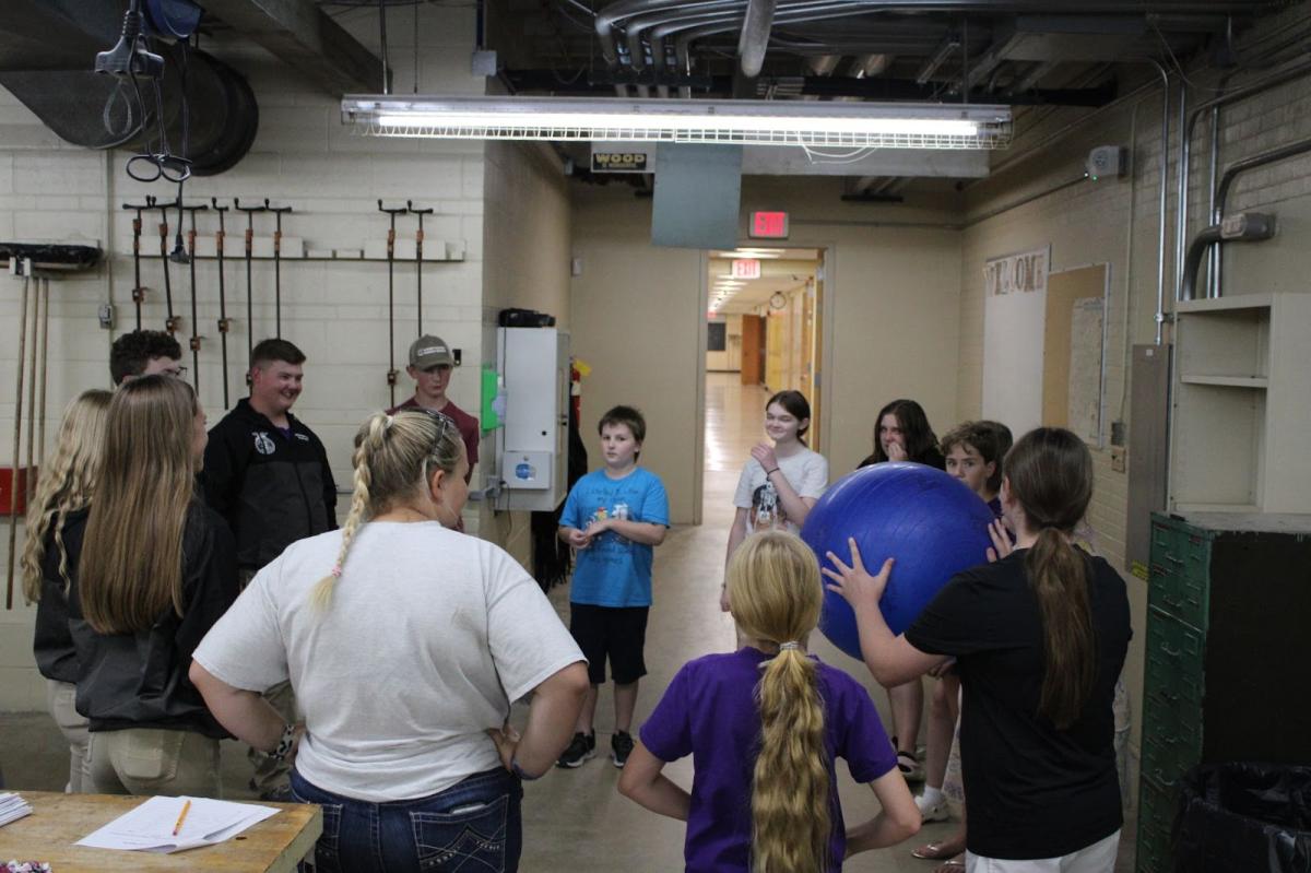 Middle school members and officers playing an ice breaker game before the sessions.