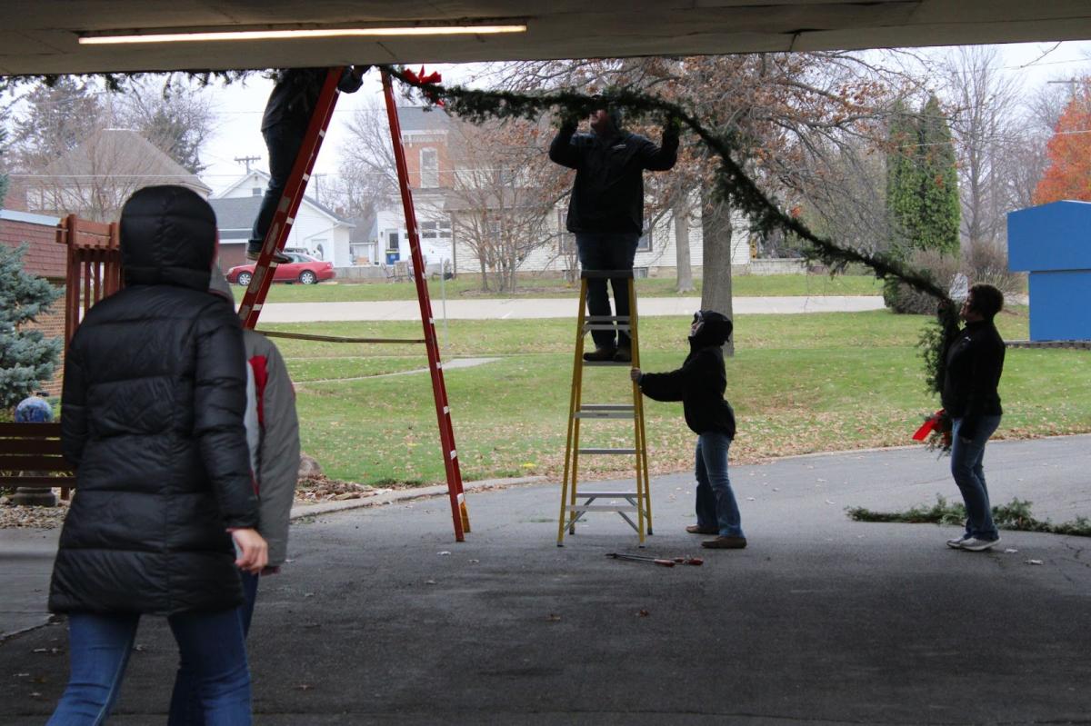 Members and volunteers helped put up the greenery for the Lutheran Living Communities.